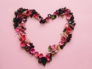 floral arrangement of pink flowers heart isolated background with place for text.