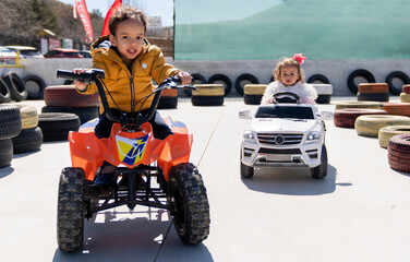 boys and girls having fun racing with battery cars. traffic education with battery car for children