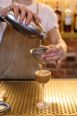 Bartender preparing espresso martini cocktail.