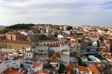 Fototapeta na wymiar Aerial drone view over Alfama District, Lisbon, Portugal. Lockdown cityscape. São Jorge Castle in the background.