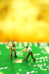 Miniature miner worker digging on graphic card find golden coin. bitcoin mining and crypto currency. A small figure digging on shiny golden Bitcoin using for Technology and online commercial concept