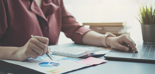 woman checking paperwork from accounting department to analyse number on document, using laptop check business database, information comparing. Typing keyboard for recording