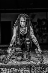 Black and white Tattooed gun girl in end time scenery