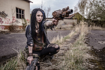 End time scenery with tattooed gun girl