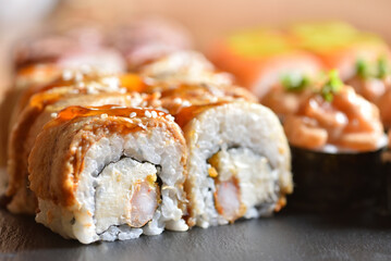 Appetizing sushi roll with eel prepared at home close-up