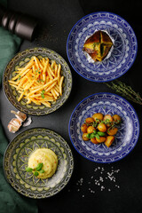 french fries in plate top view. various potato food top view. set of snacks on black concrete