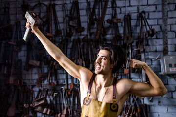 italian brunette man blacksmith working in the workshop
