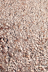Background, texture, design. Small stones are scattered on the ground.