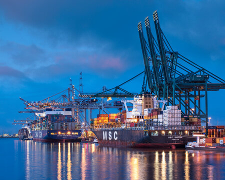 ANTWERP-MARCH 30, 2021. Illuminated container terminal at twilight. The Port of Antwerp in Flanders, Belgium is the second-largest seaport of Europe, after Rotterdam in the Netherlands.