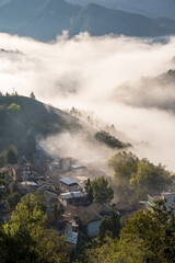 A small village in the cloud sea under sunrise.