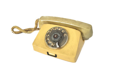 Old yellow disc telephone on a white background