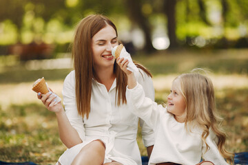 Mother with little daughter playing in a summer park