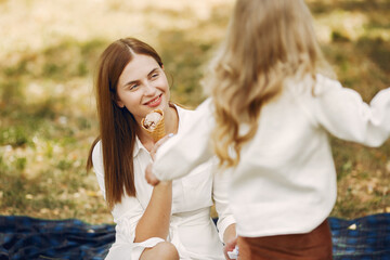 Mother with little daughter playing in a summer park