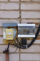 Backup power switches and electricity meter on the wall of the house outdoor