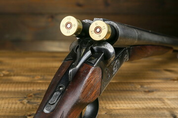 loaded hunting rifle on a wooden background close up