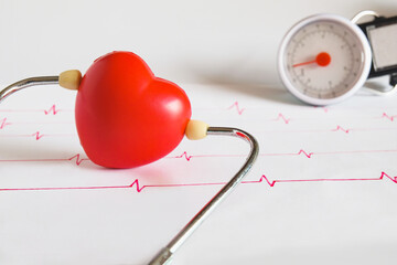 Stethoscope with red heart ball on paper heart sign wave.