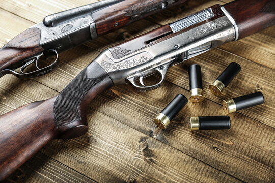 hunting rifle and cartridges on a wooden background, top view. 