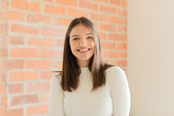 young  woman laughing shyly and cheerfully, with a friendly and positive but insecure attitude