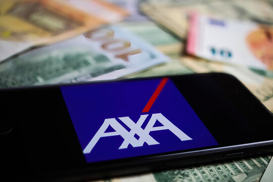 Viersen, Germany - March 1. 2021: Closeup of smartphone with logo lettering of axa insurance company on paper money currency