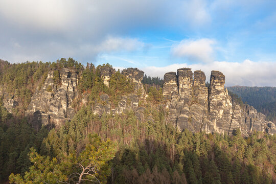 Beautiful panorama view of sandstone mountains in Saxon Switzerland National Park with Kasper, Gansfelsen and Plattenstein from Bastei bridge on a sunny day, Saxony, Germany