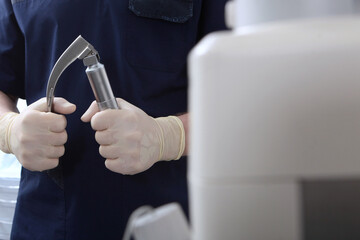 Laryngoscope in the hands of an anesthesiologist.Tracheal intubation.Preparation of equipment for...