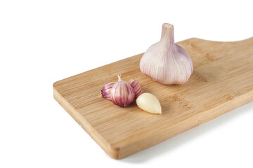 garlic on a wooden board isolated on a white background