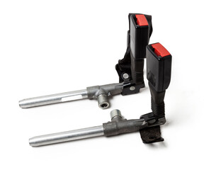 Two locks of a seat belt of a car of forward sitting with the panel for a fastening bolt and squib a plastic case of black color with red unlock keys. Spare part for replacement during repair or sale.