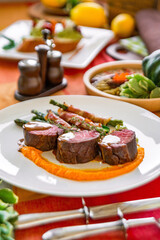 Served table in a restaurant with meat dishes
