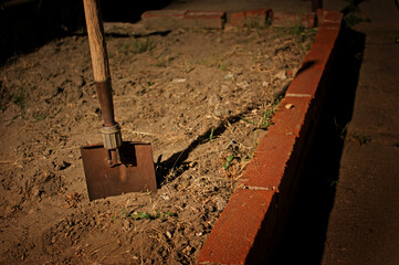 Horror scene with shovel at night after burying something