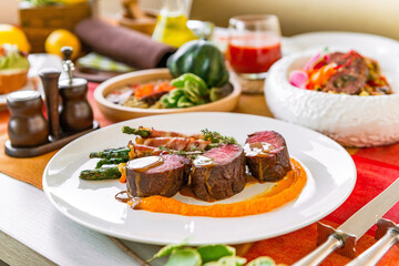 Served table in a restaurant with meat dishes