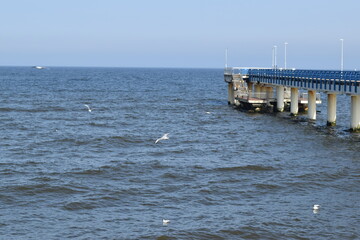 Fototapeta na wymiar Long pier on the shores of the baltic sea.