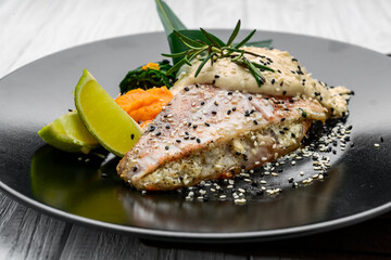 Grilled sea bass with white sauce and lemon