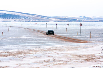 Winter ice crossing for cars across the river