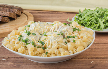 pasta with meatballs and cheese wooden table.