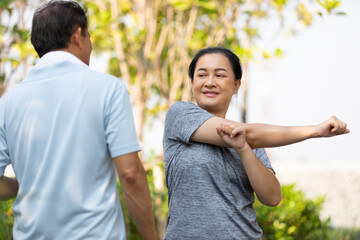 Obraz premium senior asian woman stretching and exercising outdoors