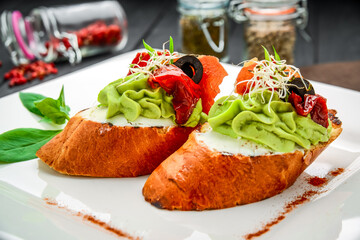 Bruschetta with avocado, prosciutto and sun-dried tomatoes