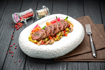 Veal roll stuffed with mushrooms with vegetable stew