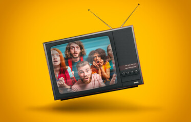 Vintage TV suspended in the air on a yellow background