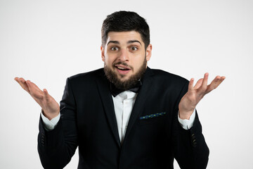 Indifferent unsure man in tuxedo makes gesture of I dont know, cant help anything. Difficult...