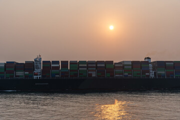 Cargo container ship departing from port of Xiamen. She is beginning voyage on her international...