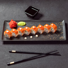 California Unagi Sushi Roll with wasabi, ginger and black chopstick