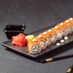 California Unagi Sushi Roll with wasabi, ginger and black chopstick
