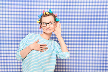 Girl with colorful hair curlers on head is eavesdropping conversation