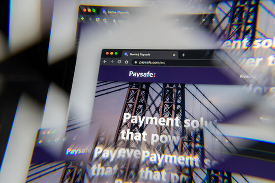 Milan, Italy - APRIL 10, 2021- Paysafe company logo  on laptop screen seen through an optical prism, creative interpretation. Dynamic and unique image from Paysafe website. Illustrative editorial.