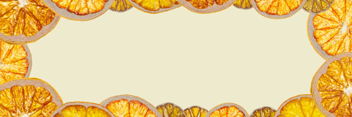 Frame bright background made of glowing different dried citrus fruits slices: lime, lemon, orange, grapefruit.