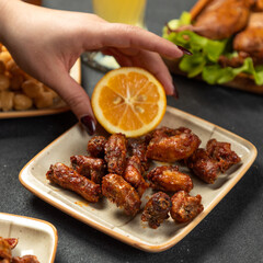 Squeezing lemon on the grilled chicken meat dish