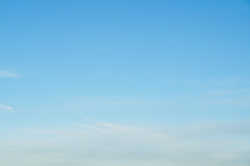 bright blue sky with soft clouds background