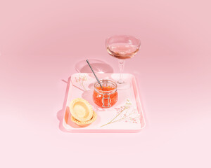 Romantic food composition with a jar of salmon red caviar, tartlets, rose wine and flowers on a tray on a pink background with hard shadows. Appetizer with sea delicacies. Gourmet sea food with wine