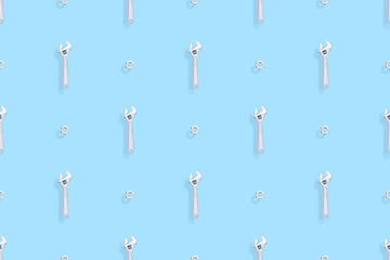 Adjustable metal wrench seamless pattern. Background from a metal wrench and nut. 