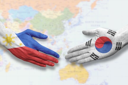 Philippines and South Korea - Flag handshake symbolizing partnership and cooperation